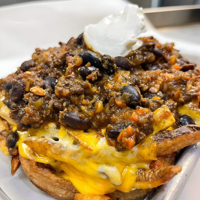 Chili cheese fries from Taps Valley Gastropub, topped with black beans and a dollop of sour cream.
